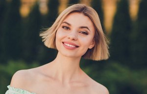 Attractive blonde woman with a sleek blonde bob with a middle parting